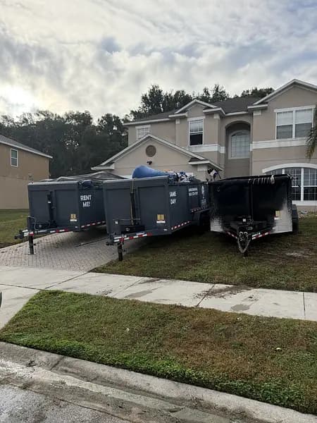Two Big Rob's Hauling dump trailers marked Rent Me parked in a Davenport, FL driveway
